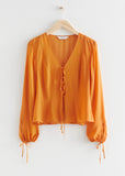 Stockholm Atelier & Other Stories orange sheer tie blouse